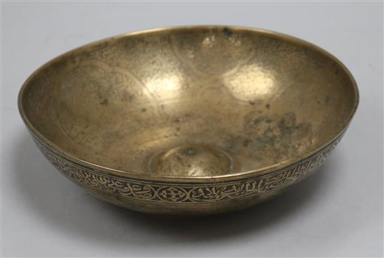 An Islamic bronze magic bowl with incised Koranic inscriptions within geometric motifs, Dia 7.5in (wear to interior)